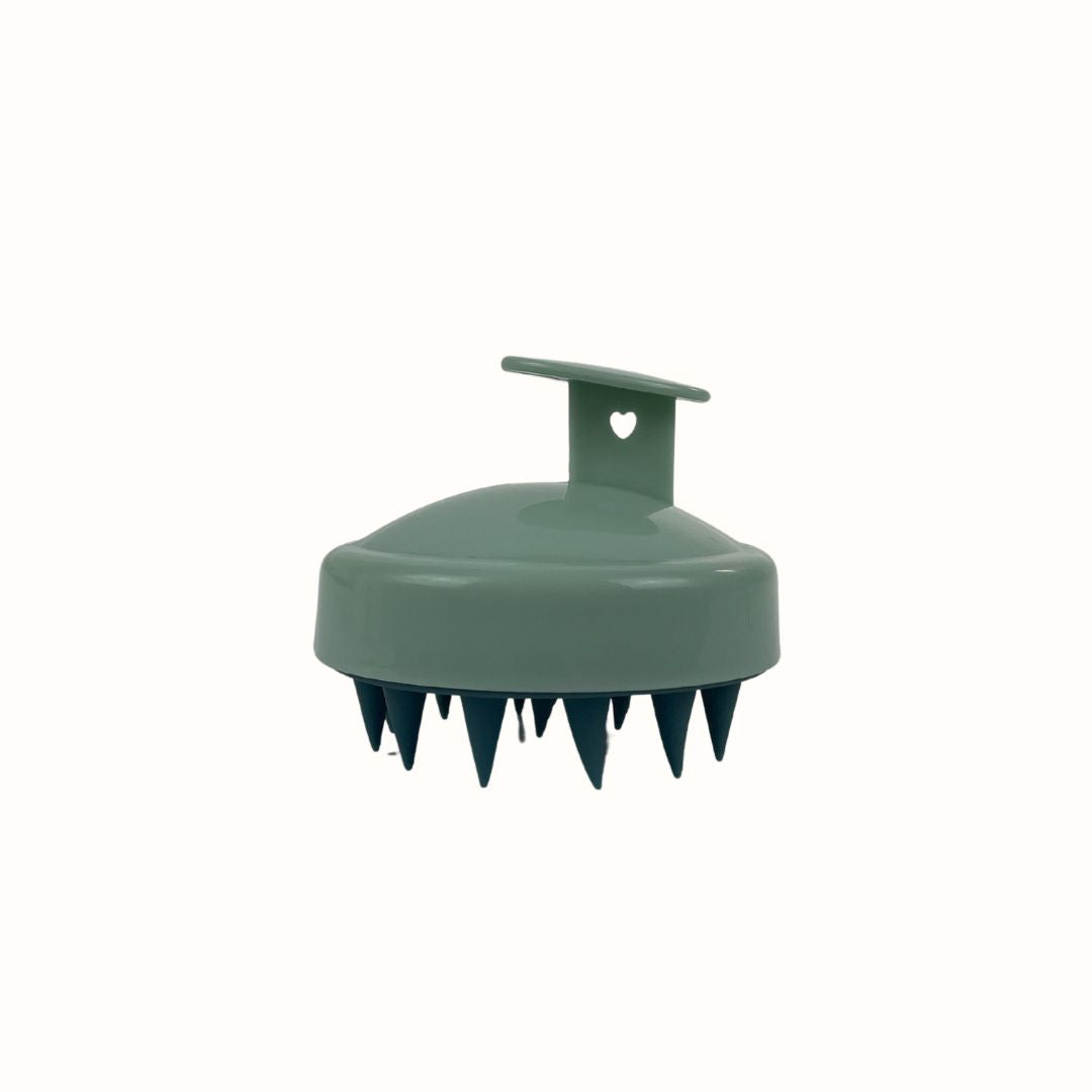 Green plastic tool with prongs on a white background
